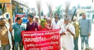 हाथों में उल्टे झाड़ू और काले झंडे लेकर पालिका कर्मचारियों ने किया रोष प्रदर्शन