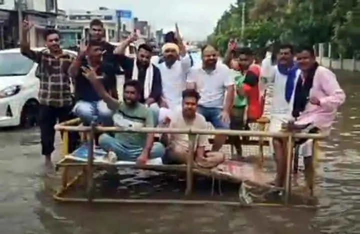 बरसाती पानी के बीच बेरिकेड्स रखकर दिया सांकेतिक धरना