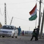 FILE PHOTO: Syrian Kurd children hold a Kurdistan national flag at Derik in Al-Hasakah