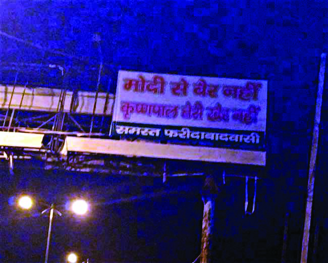 Political parapet mounted with slogan written on hoardings in Faridabad