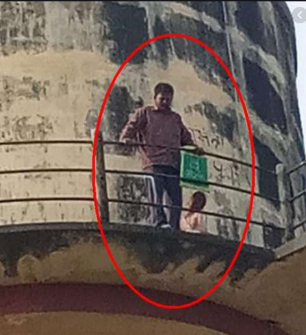 a man climbed into a water tank with his daughter for land acquisition